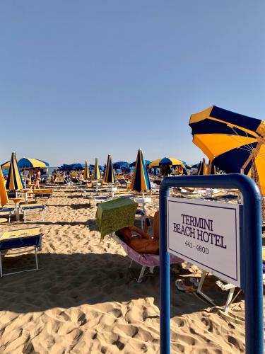 The private beach, equipped with sunbeds and umbrellas
